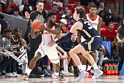 Nov 7, 2022; Houston, Texas, USA; Houston Cougars guard Jamal Shead (1) looks to pass the ball as Northern Colorado Bears guard Caleb Shaw (30) defends during the first half at Fertitta Center. Mandatory Credit: Maria Lysaker-USA TODAY Sports