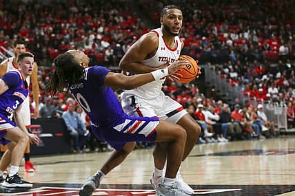 Nov 7, 2022; Lubbock, Texas, USA;  Texas Tech Red Raiders forward Kevin Obanor (0) collides with Northwestern State Demons guard Greedy Williams (10) in the first half at United Supermarkets Arena. Mandatory Credit: Michael C. Johnson-USA TODAY Sports