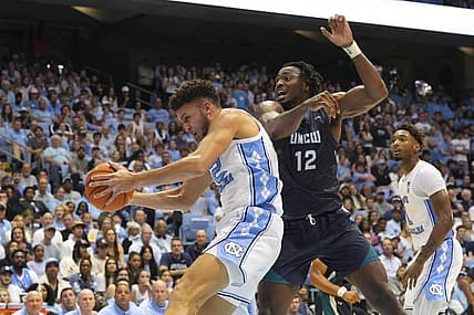 Nov 7, 2022; Chapel Hill, North Carolina, USA;  North Carolina Tar Heels forward Pete Nance (32) gets the rebound against North Carolina-Wilmington Seahawks center Victor Enoh (12) during the first half at Dean E. Smith Center. Mandatory Credit: James Guillory-USA TODAY Sports
