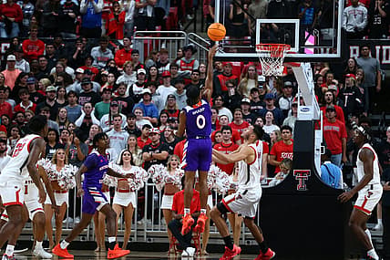 Nov 7, 2022; Lubbock, Texas, USA;  Northwestern State Demons guard Demarcus Sharp (0) shoots over Texas Tech Red Raiders forward Daniel Batcho (12) in the second half at United Supermarkets Arena. Mandatory Credit: Michael C. Johnson-USA TODAY Sports