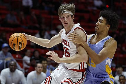 Nov 7, 2022; Salt Lake City, Utah, USA;  Utah Utes center Branden Carlson (35) drives against LIU Sharks forward C.J. Delancy (15) in the first half at Jon M. Huntsman Center. Mandatory Credit: Jeffrey Swinger-USA TODAY Sports
