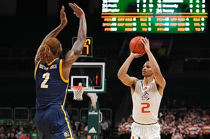 Nov 11, 2022; Coral Gables, Florida, USA; Miami Hurricanes guard Isaiah Wong (2) attempts a three point shot against the UNC Greensboro Spartans during the second half at Watsco Center. Mandatory Credit: Jasen Vinlove-USA TODAY Sports