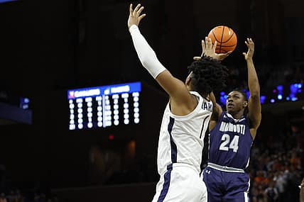 Nov 11, 2022; Charlottesville, Virginia, USA; Monmouth Hawks guard Myles Ruth (24) shoots the ball as Virginia Cavaliers forward Jayden Gardner (1) defends in the first half at John Paul Jones Arena. Mandatory Credit: Geoff Burke-USA TODAY Sports