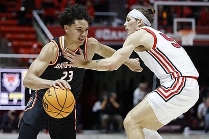 Nov 14, 2022; Salt Lake City, Utah, USA; Idaho State Bengals guard Maleek Arington (23) drives against Utah Utes guard Gabe Madsen (55) in the first half at Jon M. Huntsman Center. Mandatory Credit: Jeffrey Swinger-USA TODAY Sports