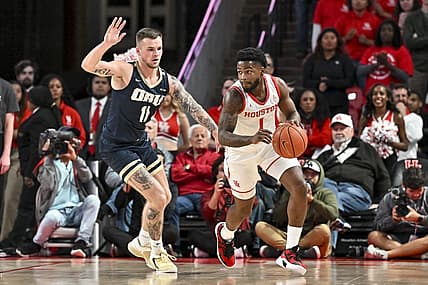 Nov 14, 2022; Houston, Texas, USA; Houston Cougars guard Jamal Shead (1) dribbles as Oral Roberts Golden Eagles guard Carlos Jurgens (11) defends during the first half at Fertitta Center. Mandatory Credit: Maria Lysaker-USA TODAY Sports