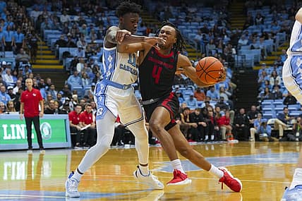 Nov 15, 2022; Chapel Hill, North Carolina, USA;  Gardner Webb Runnin Bulldogs guard DQ Nicholas (4) tries too take the ball past North Carolina Tar Heels guard D'Marco Dunn (11) during the first half at Dean E. Smith Center. Mandatory Credit: James Guillory-USA TODAY Sports