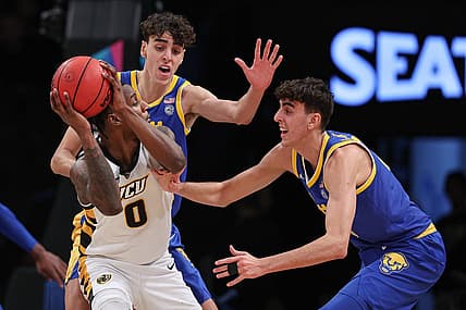 Nov 17, 2022; Brooklyn, New York, USA; Virginia Commonwealth Rams forward Jamir Watkins (0) shields the ball as Pittsburgh Panthers forward Jorge Diaz Graham (31) and forward Guillermo Diaz Graham (25) defend during the first half at Barclays Center. Mandatory Credit: Vincent Carchietta-USA TODAY Sports