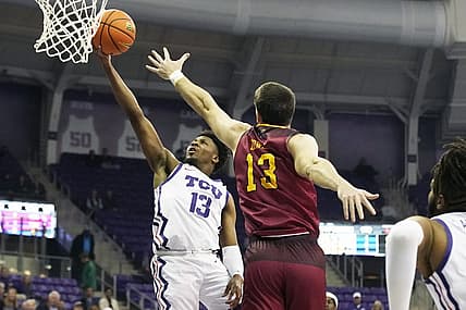 Nov 17, 2022; Fort Worth, Texas, USA; TCU Horned Frogs guard Shahada Wells (13) drives to the basket on Louisiana Monroe Warhawks forward Thomas Howell (13) during the first half at Ed and Rae Schollmaier Arena. Mandatory Credit: Raymond Carlin III-USA TODAY Sports