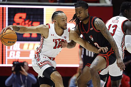 Nov 17, 2022; Salt Lake City, Utah, USA; Utah Utes guard Marco Anthony (10) drives against guard Ronnie Stapp (3) in the fits half at Jon M. Huntsman Center. Mandatory Credit: Jeffrey Swinger-USA TODAY Sports