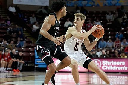Nov 18, 2022; Charleston, South Carolina, USA; Davidson Wildcats guard Grant Huffman (5) drives around South Carolina Gamecocks guard Jacobi Wright (1) in the first half at TD Arena. Mandatory Credit: David Yeazell-USA TODAY Sports