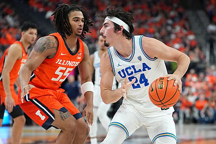 Nov 18, 2022; Las Vegas, Nevada, USA; UCLA Bruins guard Jaime Jaquez Jr. (24) dribbles against Illinois Fighting Illini guard Skyy Clark (55) during the second half at T-Mobile Arena. Mandatory Credit: Stephen R. Sylvanie-USA TODAY Sports