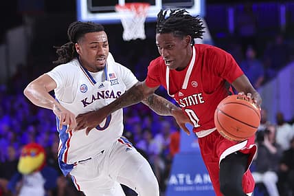 Nov 23, 2022; Paradise Island, BAHAMAS; North Carolina State Wolfpack guard Terquavion Smith (0) drives to the basket as Kansas Jayhawks guard Bobby Pettiford Jr. (0) defends during the second half at Imperial Arena. Mandatory Credit: Kevin Jairaj-USA TODAY Sports