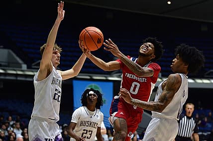 Nov 23, 2022; Anaheim, California, USA; Fresno State Bulldogs guard Donavan Yap (0) moves to the basket against Washington Huskies guard Cole Bajema (22) forward Langston Wilson (13) during the first half at Anaheim Convention Center. Mandatory Credit: Gary A. Vasquez-USA TODAY Sports