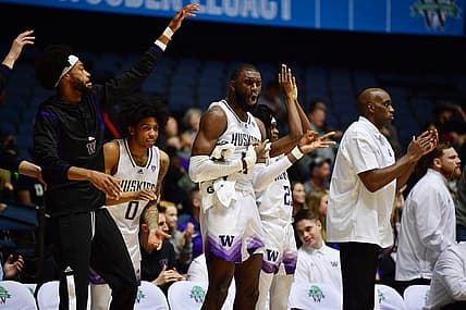 Nov 23, 2022; Anaheim, California, USA; Washington Huskies center Franck Kepnang (11) and the bench react against the Fresno State Bulldogs during the second half at Anaheim Convention Center. Mandatory Credit: Gary A. Vasquez-USA TODAY Sports