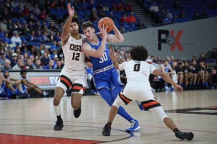Nov 24, 2022; Portland, Oregon, USA;  Duke Blue Devils center Kyle Filipowski (30) drives to the basket during the first half against Oregon State Beavers forward Michael Rataj (12) and guard Jordan Pope (0) at Veterans Memorial Coliseum. Mandatory Credit: Troy Wayrynen-USA TODAY Sports