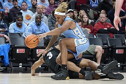 Nov 24, 2022; Portland, Oregon, USA; North Carolina Tar Heels forward Armando Bacot (5) and Portland Pilots forward Alden Applewhite (3) scramble for the ball during the second half at Moda Center. North Carolina won the game 89-81. Mandatory Credit: Troy Wayrynen-USA TODAY Sports