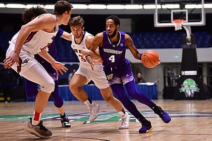 Nov 24, 2022; Anaheim, California, USA; Washington Huskies guard PJ Fuller II (4) moves the ball against St. Mary's Gaels guard Augustas Marciulionis (3) and center Mitchell Saxen (11) during the first half at Anaheim Convention Center. Mandatory Credit: Gary A. Vasquez-USA TODAY Sports