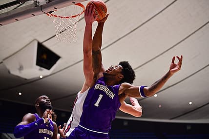Nov 24, 2022; Anaheim, California, USA; Washington Huskies forward Keion Brooks (1) plays for the ball against St. Mary's Gaels center Mitchell Saxen (11)  during the second half at Anaheim Convention Center. Mandatory Credit: Gary A. Vasquez-USA TODAY Sports