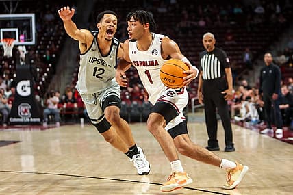 Nov 25, 2022; Charleston, South Carolina, USA; South Carolina Gamecocks guard Jacobi Wright (1) drives around USC Upstate Spartans guard Trae Broadnax (12) in the first half at Colonial Life Arena. Mandatory Credit: Jeff Blake-USA TODAY Sports