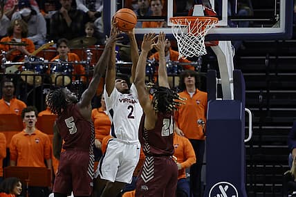 Nov 25, 2022; Charlottesville, Virginia, USA; Virginia Cavaliers guard Reece Beekman (2) attempts to dunk the bal as Maryland-Eastern Shore Hawks guard Da'Shawn Phillip (5) and Hawks forward Troy Hupstead (24) defend in the first half at John Paul Jones Arena. Mandatory Credit: Geoff Burke-USA TODAY Sports