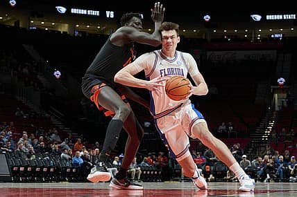 Nov 25, 2022; Portland, Oregon, USA; Florida Gators forward Colin Castleton (12) drives to the basket during the first half against Oregon State Beavers center Chol Marial (15) at Veterans Memorial Coliseum. Mandatory Credit: Troy Wayrynen-USA TODAY Sports