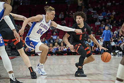 Nov 25, 2022; Portland, Oregon, USA; Oregon State Beavers guard Jordan Pope (0) dribbles the ball during the second half against Florida Gators guard Riley Kugel (24)  at Moda Center. Mandatory Credit: Troy Wayrynen-USA TODAY Sports