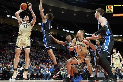 Nov 27, 2022; Portland, Oregon, USA;  Purdue Boilermakers center Zach Edey (15) shoots a basket during the first half against Duke Blue Devils center Dereck Lively II (1) at Moda Center. Mandatory Credit: Troy Wayrynen-USA TODAY Sports