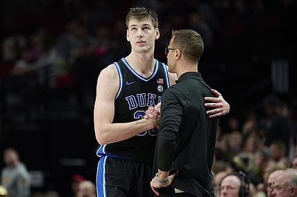 Nov 27, 2022; Portland, Oregon, USA;  Duke Blue Devils center Kyle Filipowski (30) shakes hand with head coach Jon Scheyer after fouling out of the game during the second half against the Purdue Boilermakers at Moda Center. Purdue won the Phil Knight Legacy Championship game 75-56. Mandatory Credit: Troy Wayrynen-USA TODAY Sports