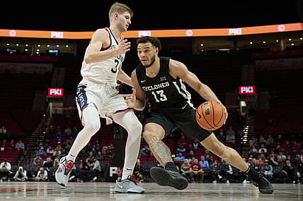 Nov 27, 2022; Portland, Oregon, USA;  Iowa State Cyclones guard Jaren Holmes (13) drives to the basket during the second half against Connecticut Huskies guard Joey Calcaterra (3) at Moda Center. The Huskies won the Phil Knight Invitational Basketball Tournament 71-53. Mandatory Credit: Troy Wayrynen-USA TODAY Sports
