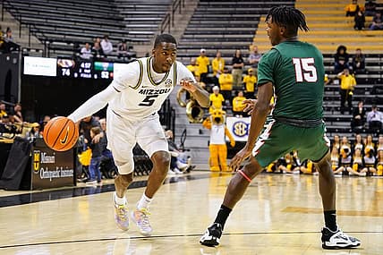 Nov 20, 2022; Columbia, Missouri, USA; Missouri Tigers guard D'Moi Hodge (5) drives against Mississippi Valley State Delta Devils forward Alvin Stredic (15) during the second half at Mizzou Arena. Mandatory Credit: Jay Biggerstaff-USA TODAY Sports