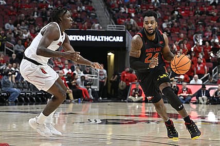 Nov 29, 2022; Louisville, Kentucky, USA;  Maryland Terrapins forward Donta Scott (24) dribbles against Louisville Cardinals guard Mike James (1) during the first half at KFC Yum! Center. Mandatory Credit: Jamie Rhodes-USA TODAY Sports