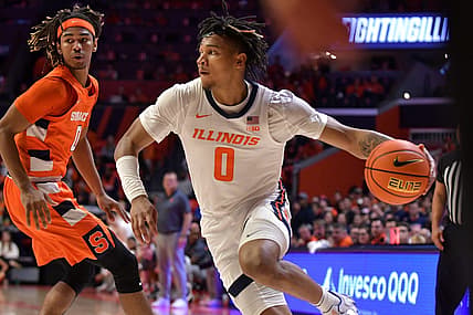 Nov 29, 2022; Champaign, Illinois, USA; Illinois Fighting Illini guard Terrence Shannon Jr. (0) drives the ball past Syracuse Orange forward Chris Bell (0) during the first half at State Farm Center. Mandatory Credit: Ron Johnson-USA TODAY Sports