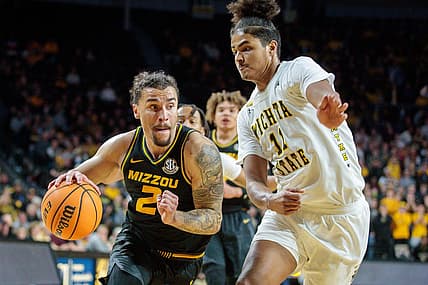 Nov 29, 2022; Wichita, Kansas, USA; Missouri Tigers guard Tre Gomillion (2) drives to the basket around Wichita State Shockers forward Kenny Pohto (11) during the first half at Charles Koch Arena. Mandatory Credit: William Purnell-USA TODAY Sports