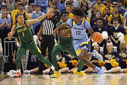Nov 29, 2022; Milwaukee, Wisconsin, USA;  Marquette Golden Eagles forward Olivier-Maxence Prosper (12) drives fore the basket against Baylor Bears forward Josh Ojianwuna (15) during the first half at Fiserv Forum. Mandatory Credit: Jeff Hanisch-USA TODAY Sports