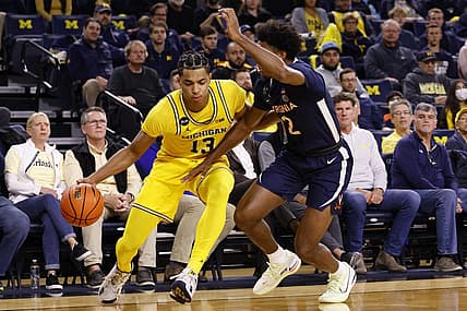 Nov 29, 2022; Ann Arbor, Michigan, USA; Michigan Wolverines guard Jett Howard (13) dribbles defended by Virginia Cavaliers guard Reece Beekman (2) in the first half at Crisler Center. Mandatory Credit: Rick Osentoski-USA TODAY Sports