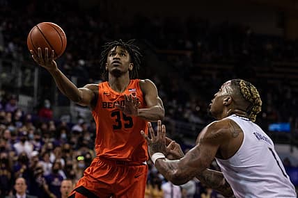 Mar 5, 2022; Seattle, Washington, USA; Oregon State Beavers forward Glenn Taylor Jr. (35) shoots the ball against Washington Huskies forward Nate Roberts (1) at Alaska Airlines Arena at Hec Edmundson Pavilion. Mandatory Credit: Stephen Brashear-USA TODAY Sports