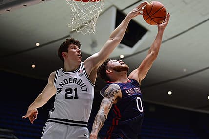 Nov 23, 2022; Anaheim, California, USA; Vanderbilt Commodores forward Liam Robbins (21) blocks the shot of St. Mary's Gaels guard Logan Johnson (0) during the first half at Anaheim Convention Center. Mandatory Credit: Gary A. Vasquez-USA TODAY Sports