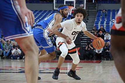 Nov 24, 2022; Portland, Oregon, USA; Oregon State Beavers guard Jordan Pope (0) drives to the basket during the second half against Duke Blue Devils guard Jacob Grandison (13) at Veterans Memorial Coliseum. Duke won the game 54-51. Mandatory Credit: Troy Wayrynen-USA TODAY Sports