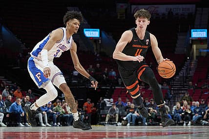 Nov 25, 2022; Portland, Oregon, USA;  Oregon State Beavers forward Dzmitry Ryuny (11) drives to the basket during the second half against Florida Gators forward Alex Fudge (3) at Moda Center. Florida won 81-68. Mandatory Credit: Troy Wayrynen-USA TODAY Sports