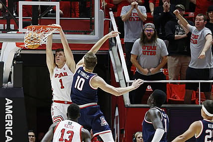 Dec 1, 2022; Salt Lake City, Utah, USA;  Utah Utes forward Ben Carlson (1) dunks against Arizona Wildcats forward Azuolas Tubelis (10) in the first half at Jon M. Huntsman Center. Mandatory Credit: Jeffrey Swinger-USA TODAY Sports