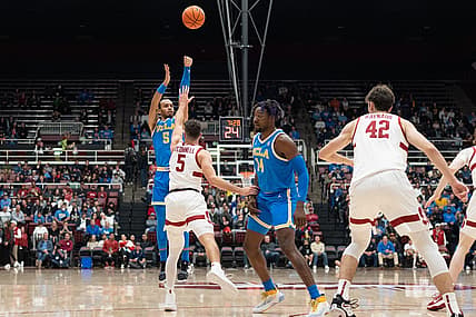 Dec 1, 2022; Stanford, California, USA; UCLA Bruins guard Amari Bailey (5) shoots the ball over Stanford Cardinal guard Michael O'Connell (5) during the first half at Maples Pavilion. Mandatory Credit: Stan Szeto-USA TODAY Sports