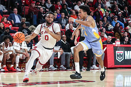 Nov 29, 2022; Queens, New York, USA;  St. John's Red Storm guard Posh Alexander (0) and Long Island University Sharks guard Jacob Johnson (4) at Carnesecca Arena. Mandatory Credit: Wendell Cruz-USA TODAY Sports