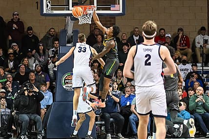 Dec 2, 2022; Sioux Falls, South Dakota, USA;  Baylor Bears guard Langston Love (13) dunks on Gonzaga Bulldogs forward Ben Gregg (33) in the first half at Sanford Pentagon. Mandatory Credit: Steven Branscombe-USA TODAY Sports