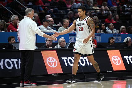 Dec 2, 2022; San Diego, California, USA; San Diego State Aztecs guard Matt Bradley (20) is greeted by head coach Brian Dutcher (left) during a substitution in the second half against the Occidental Tigers at Viejas Arena. Mandatory Credit: Orlando Ramirez-USA TODAY Sports