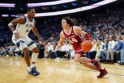 Dec 3, 2022; Philadelphia, Pennsylvania, USA; Oklahoma Sooners guard Bijan Cortes (14) dribbles the ball against Villanova Wildcats forward Eric Dixon (43) during the first half at Wells Fargo Center. Mandatory Credit: Gregory Fisher-USA TODAY Sports