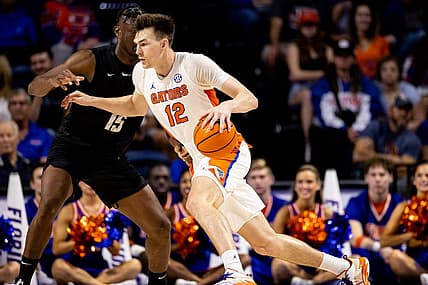 Dec 4, 2022; Gainesville, Florida, USA; Florida Gators forward Colin Castleton (12) drives to the basket against Stetson Hatters forward Mahamadou Diawara (15) during the first half at Exactech Arena at the Stephen C. O'Connell Center. Mandatory Credit: Matt Pendleton-USA TODAY Sports