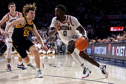Dec 4, 2022; Tucson, Arizona, USA; Arizona Wildcats guard Courtney Ramey (0) drives to the basket against California Golden Bears guard Devin Askew (55) during the second half at McKale Center. Mandatory Credit: Zachary BonDurant-USA TODAY Sports