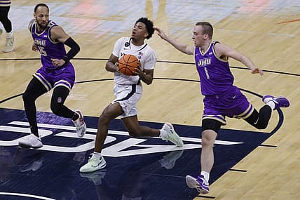 Dec 6, 2022; Charlottesville, Virginia, USA; Virginia Cavaliers guard Reece Beekman (2) drives to the basket as James Madison Dukes guard Takal Molson (15) and Dukes guard Noah Freidel (1) defend in the first half at John Paul Jones Arena. Mandatory Credit: Geoff Burke-USA TODAY Sports