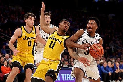 Dec 6, 2022; New York, New York, USA; Duke Blue Devils guard Jeremy Roach (3) is fouled by Iowa Hawkeyes guard Tony Perkins (11) as he drives to the basket during the first half at Madison Square Garden. Mandatory Credit: Brad Penner-USA TODAY Sports