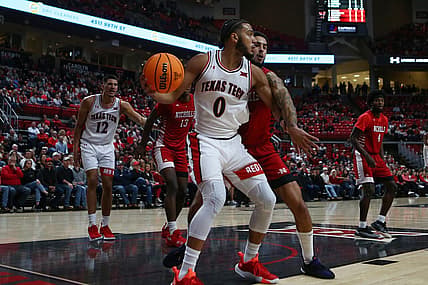 Dec 7, 2022; Lubbock, Texas, USA;  Texas Tech Red Raiders forward Kevin Obanor (0) works the ball against Nicholls Colonels forward Marek Nelson (0) in the first half at United Supermarkets Arena. Mandatory Credit: Michael C. Johnson-USA TODAY Sports